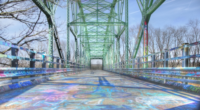 Graffiti covers the abandoned bridge